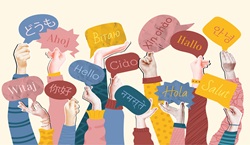 Hands holding up hello signs in different languages